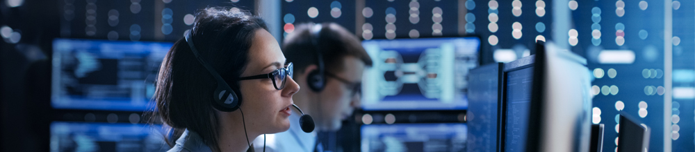woman with headset in control room